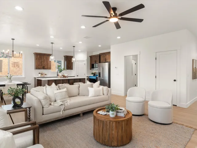 Spacious open-concept living area featuring light wood-finish flooring and recessed lighting