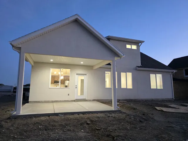 Rear exterior with covered patio featuring recessed lighting