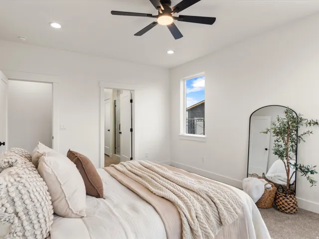 Bright interior featuring a ceiling fan, recessed lighting, and a window with exterior visibility