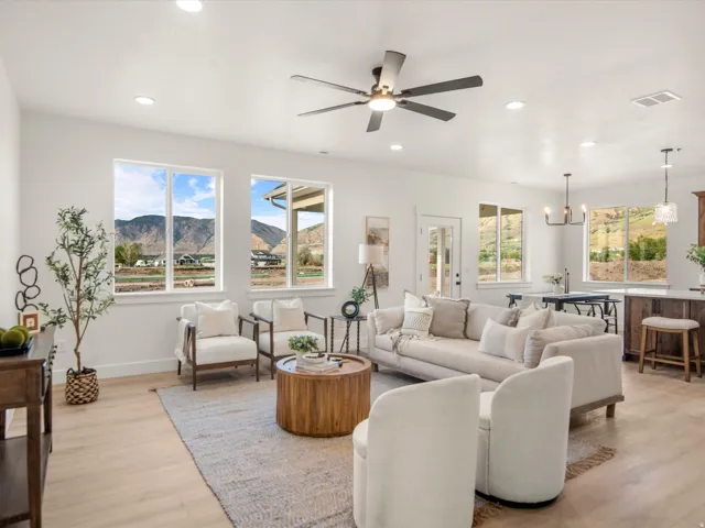 Open-concept living area featuring light wood-finish flooring and recessed lighting