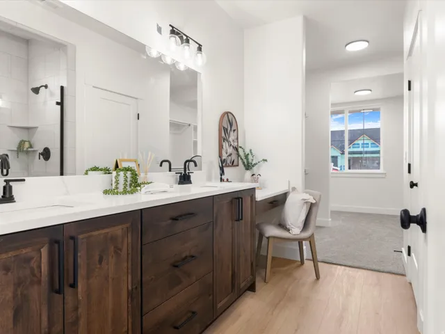 Dual sink vanity with dark wood-finish cabinetry and white countertops