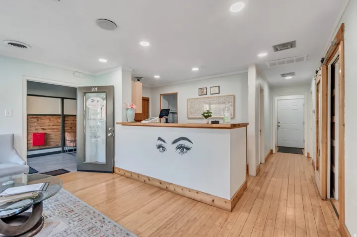 Hardwood-finish flooring extending through the space