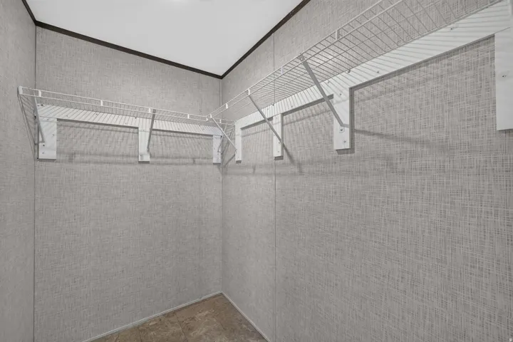 Corner closet featuring white wire shelving