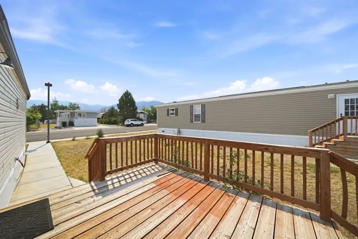 Wood-finish deck with railing and steps