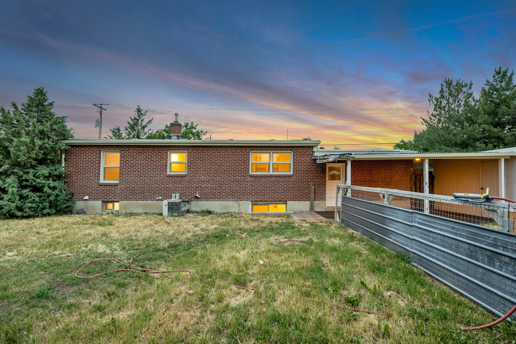 Brick exterior with a covered entry and an attached carport