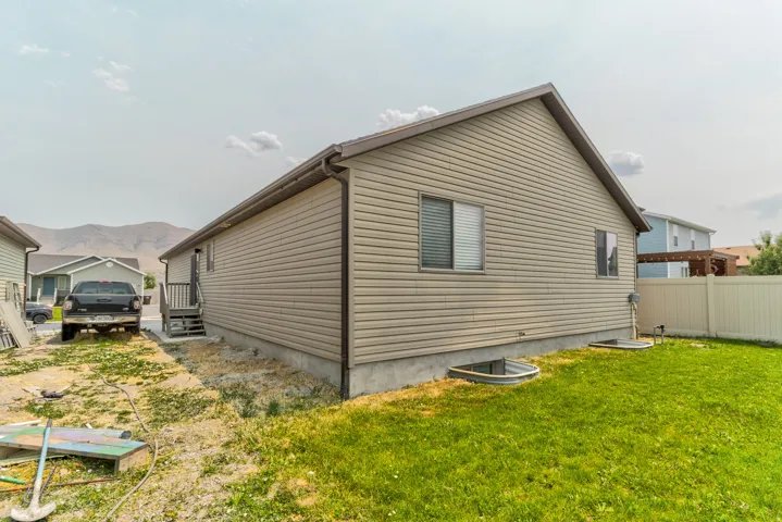 Neutral-toned siding exterior with a dark brown pitched roof