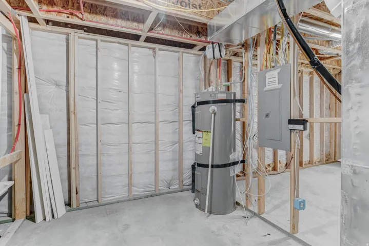 Unfinished basement space with exposed wooden framing and concrete flooring