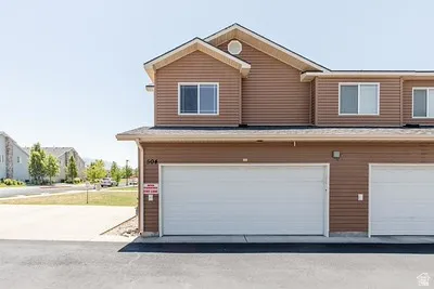 Townhouse-style exterior featuring horizontal siding and a prominent two-car garage