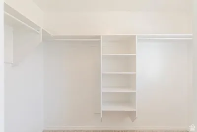 Built-in closet system featuring white shelving and hanging rods