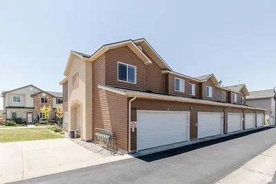 Multi-unit property with tan stucco and brown siding