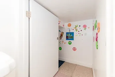 Recessed alcove with white walls and a light-colored carpeted floor