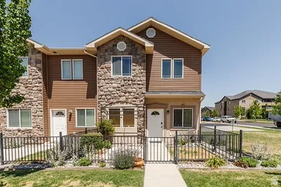 Two-story multi-unit exterior featuring stone veneer and horizontal siding