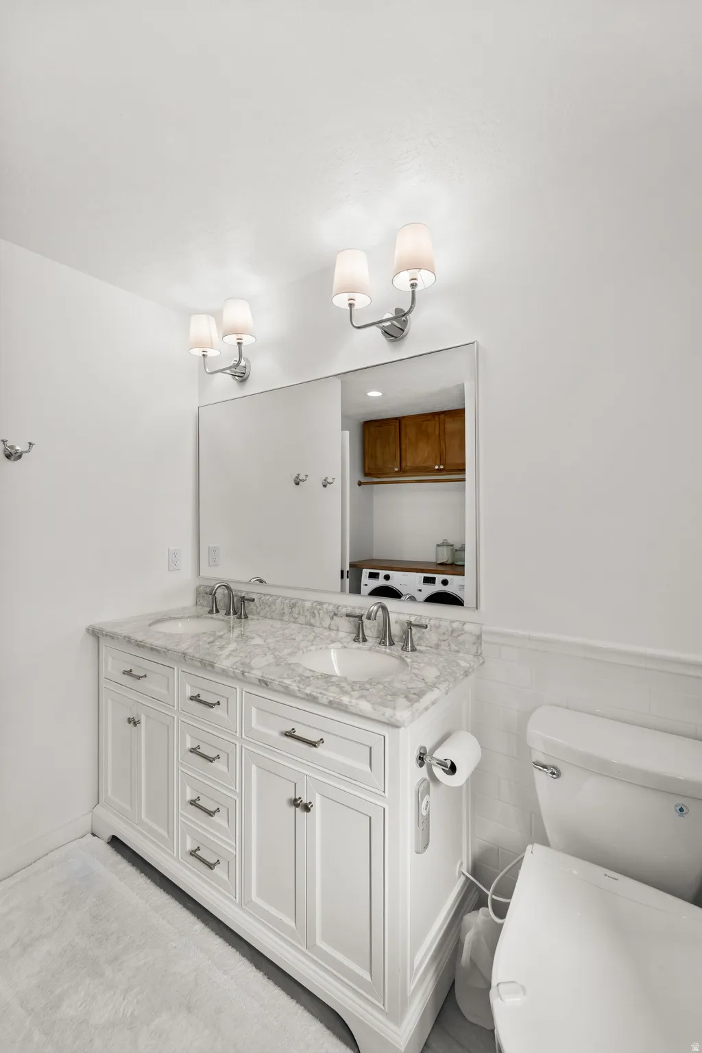 Dual vanity with white cabinetry, a light-toned countertop, and undermount sinks