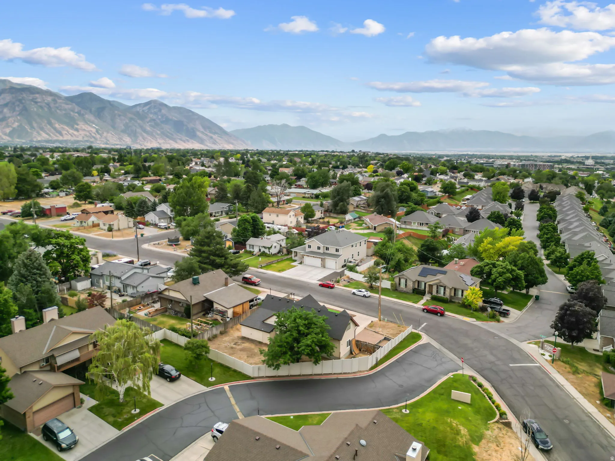 Aerial perspective of a residential neighborhood with distant mountain ranges