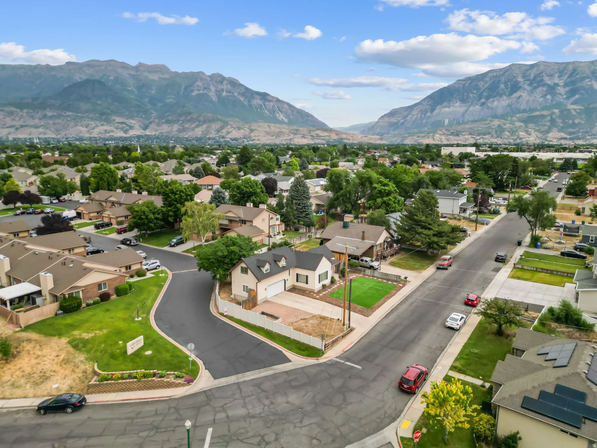 Aerial perspective showcasing a residential neighborhood with distant mountains