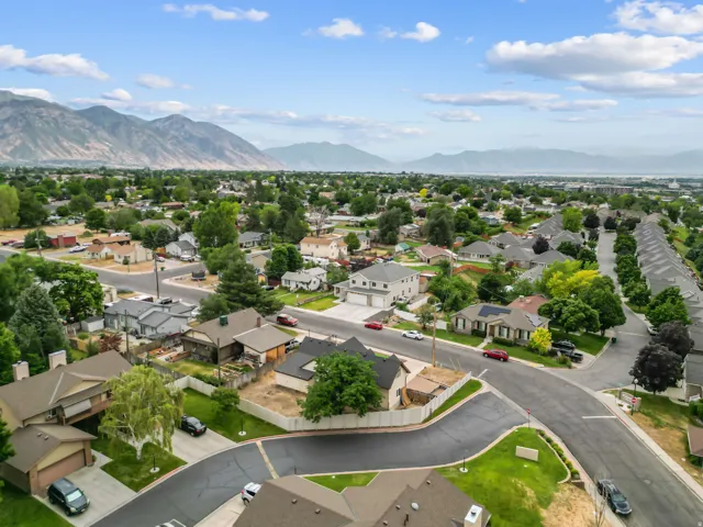 Aerial perspective of a residential neighborhood with distant mountain ranges