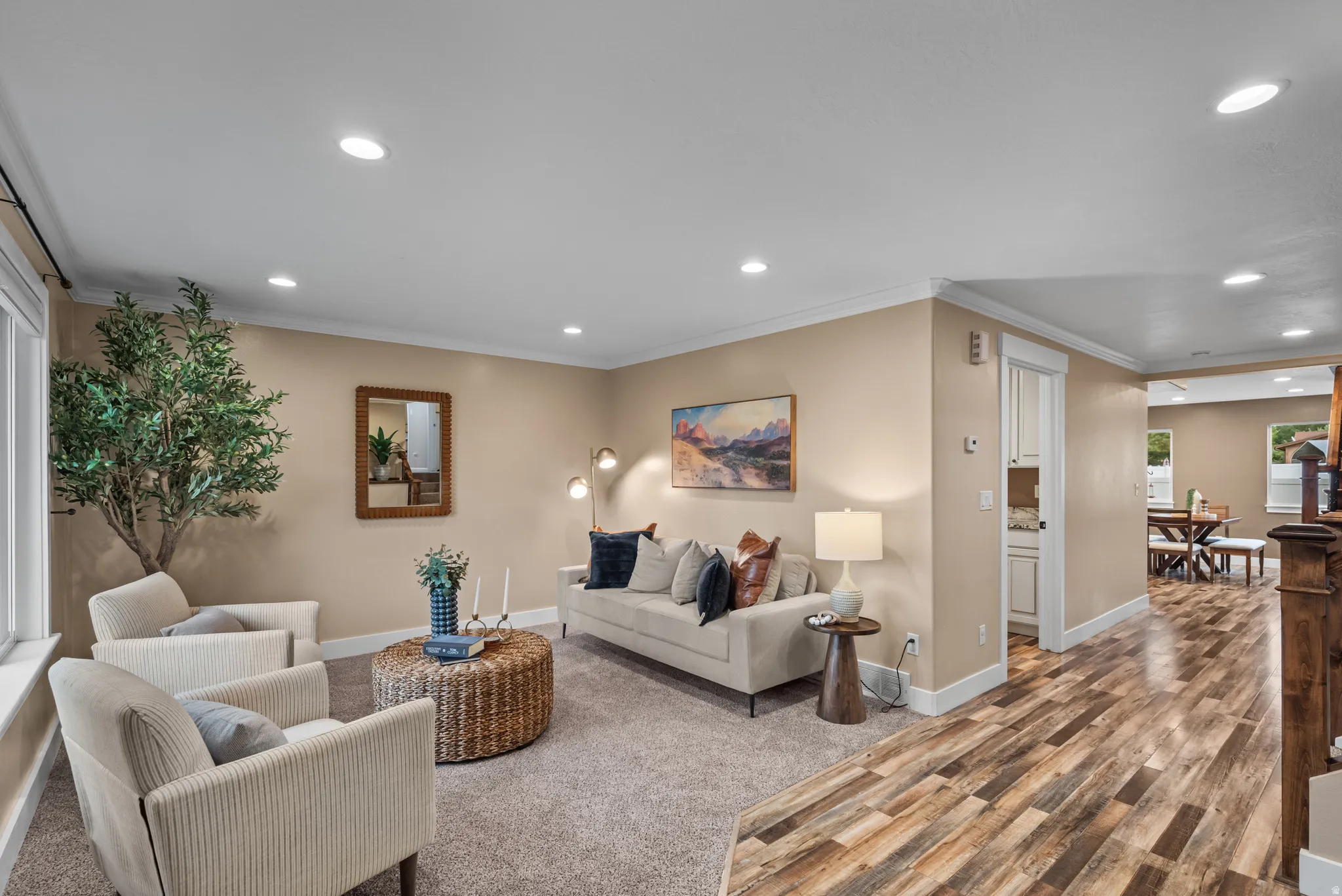Spacious living area featuring recessed lighting, crown molding, and neutral wall tones