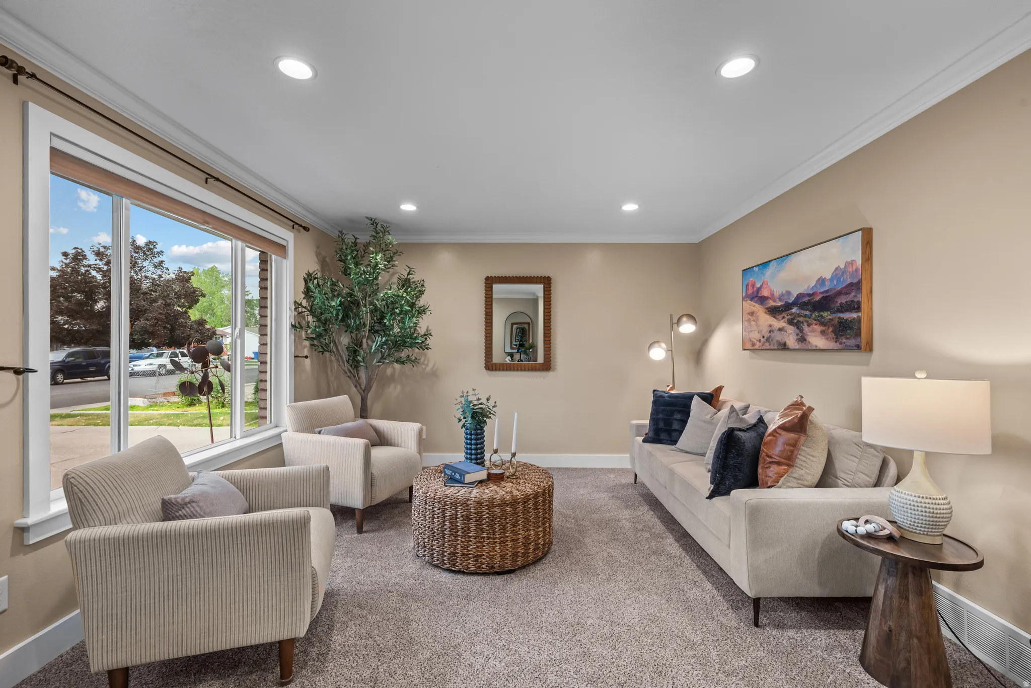Living room featuring a large picture window, recessed lighting, crown molding, and neutral-toned wall paint
