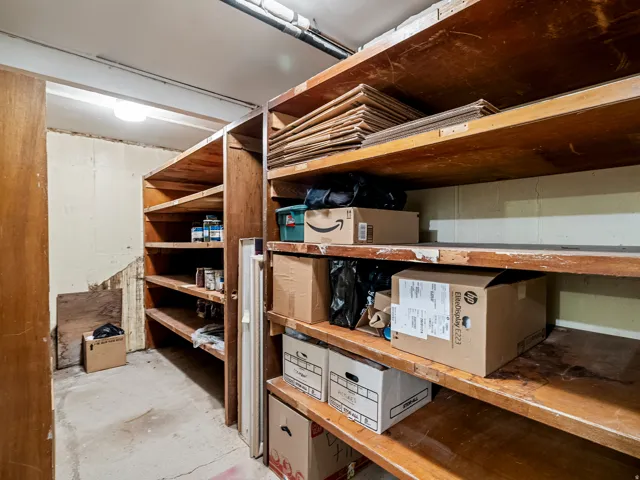 Utility room featuring built-in wooden shelving for storage