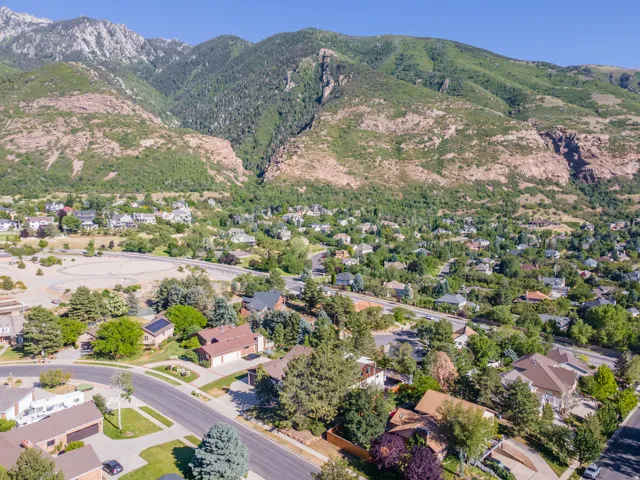 Residential area nestled at the base of a prominent mountain range