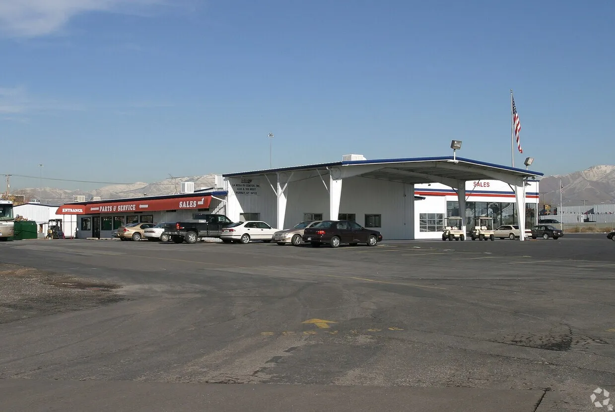Commercial property featuring a large asphalt parking lot