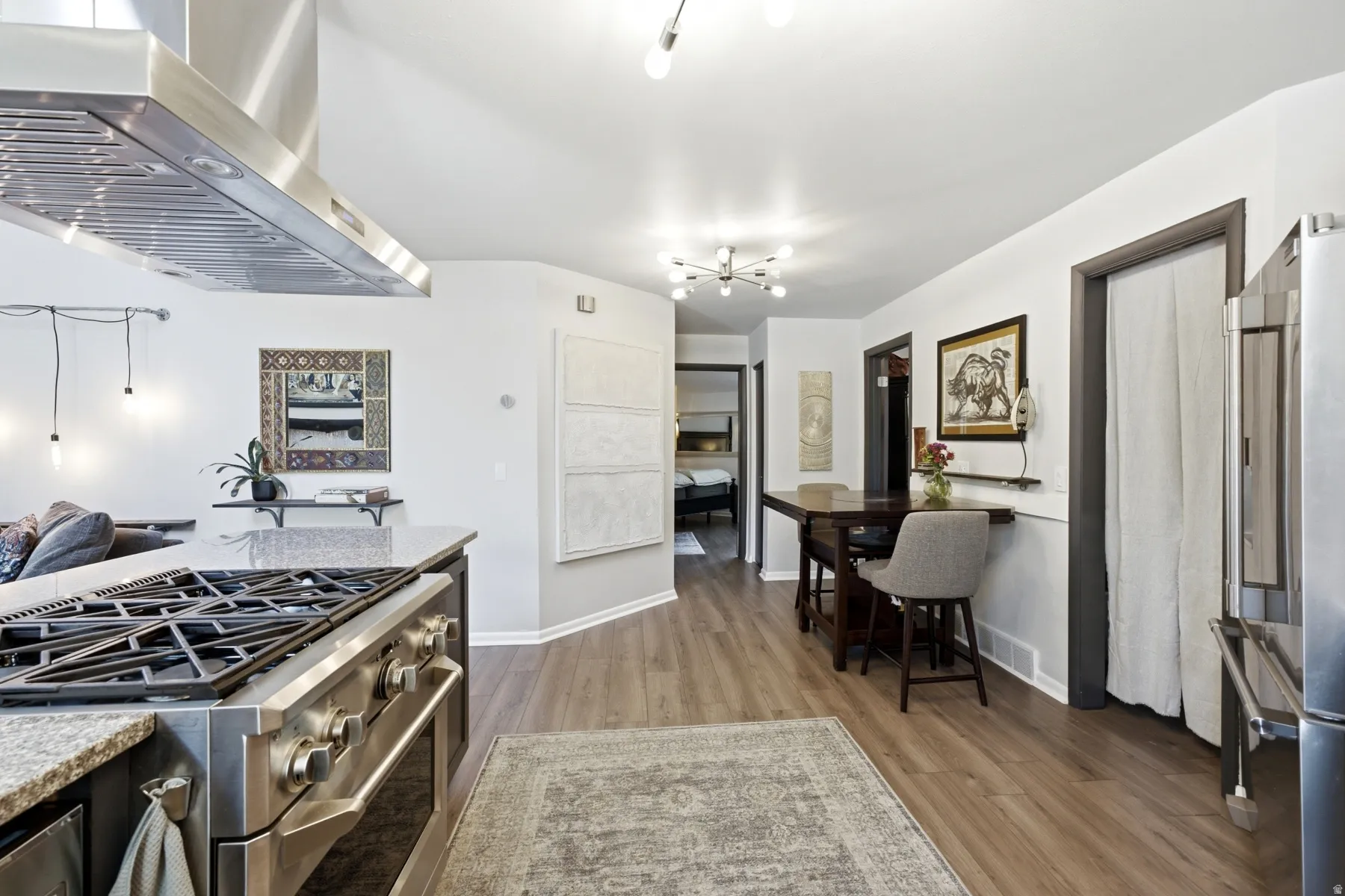 Gourmet kitchen with professional-grade stainless steel range and coordinating exhaust hood