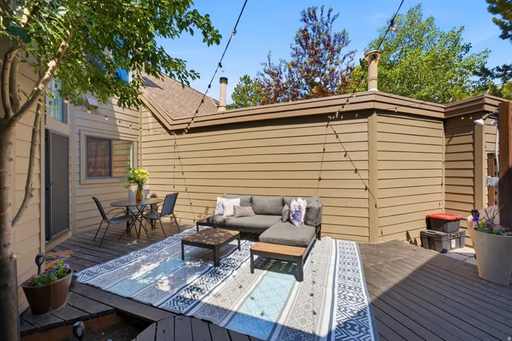 Expansive outdoor deck area featuring wood decking and integrated landscaping