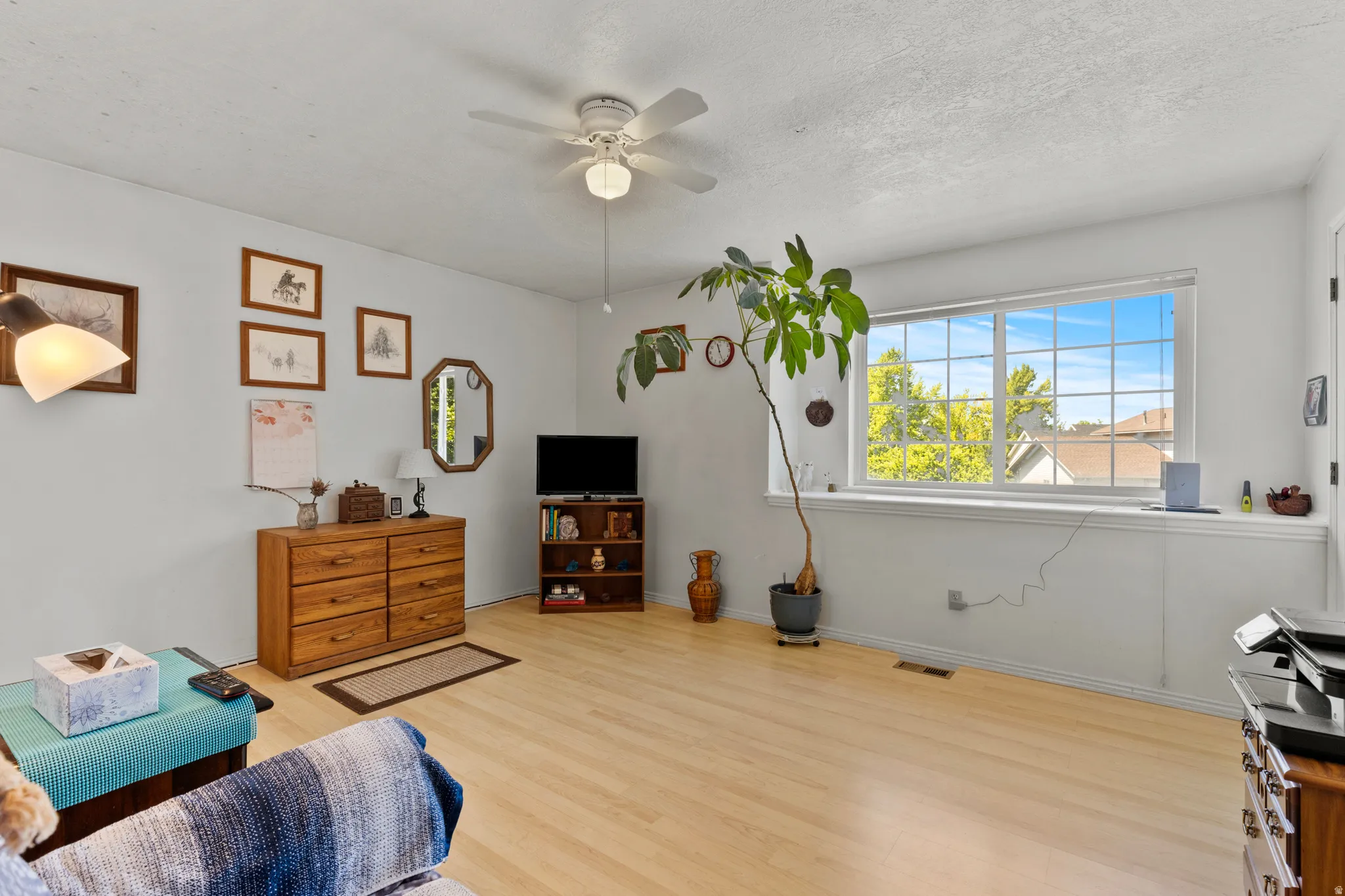Bedroom featuring light wood-finish flooring and a ceiling fan