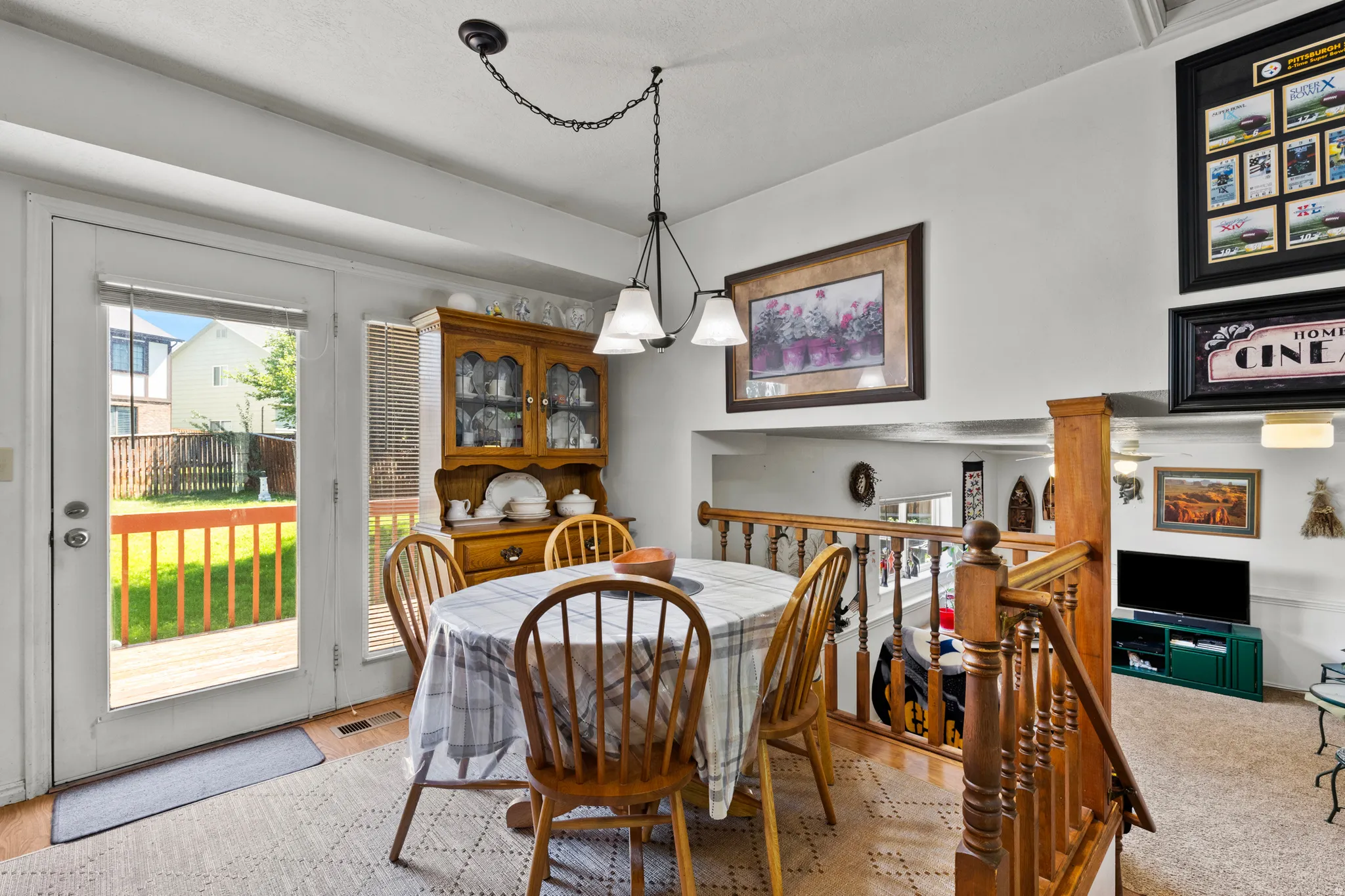 Dining area featuring a glass-paneled door opening to an exterior deck with wood railings