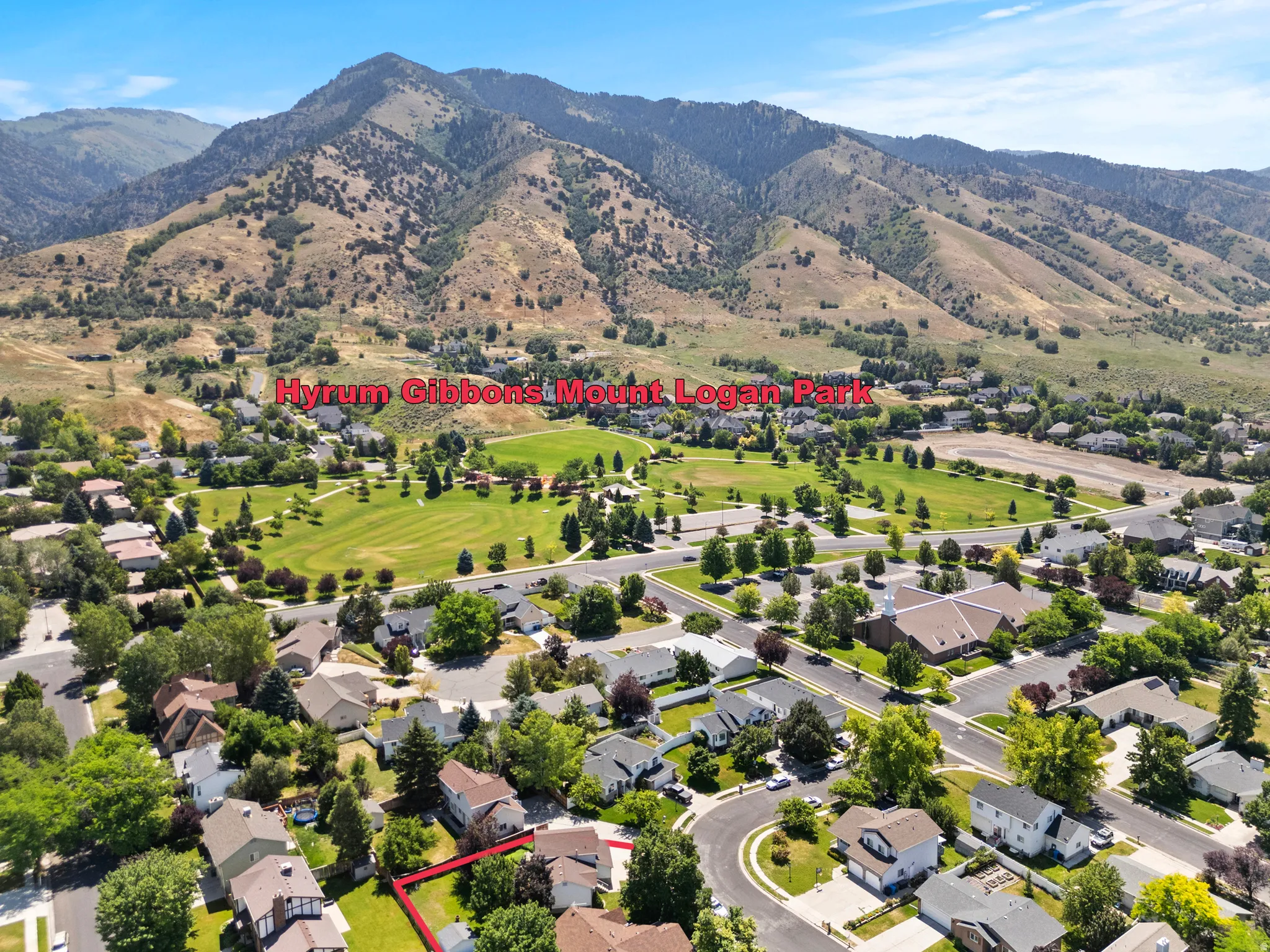 Aerial perspective showcasing a residential neighborhood with a prominent mountainous backdrop