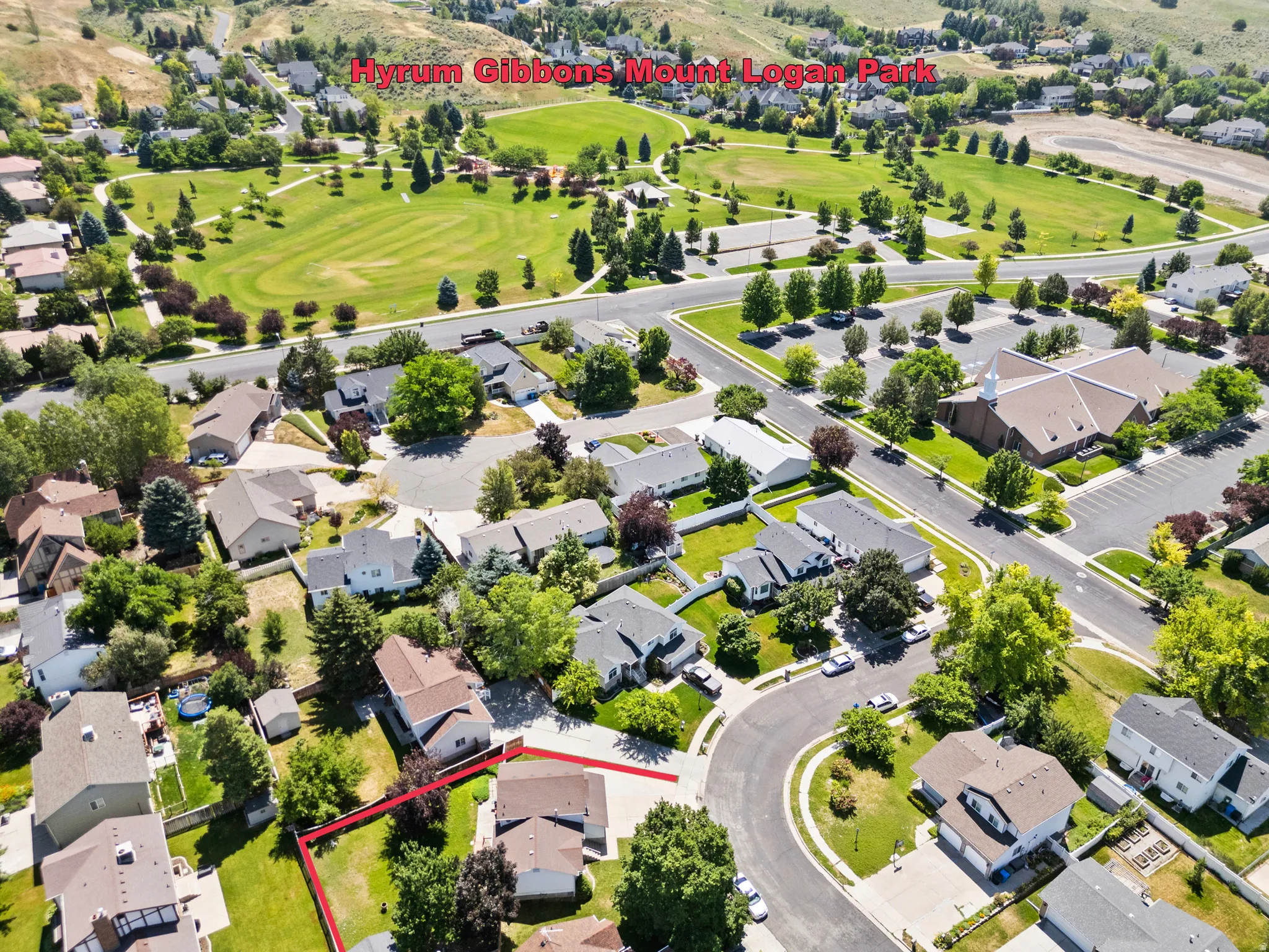 Aerial perspective showcasing a residential neighborhood with a park nearby.