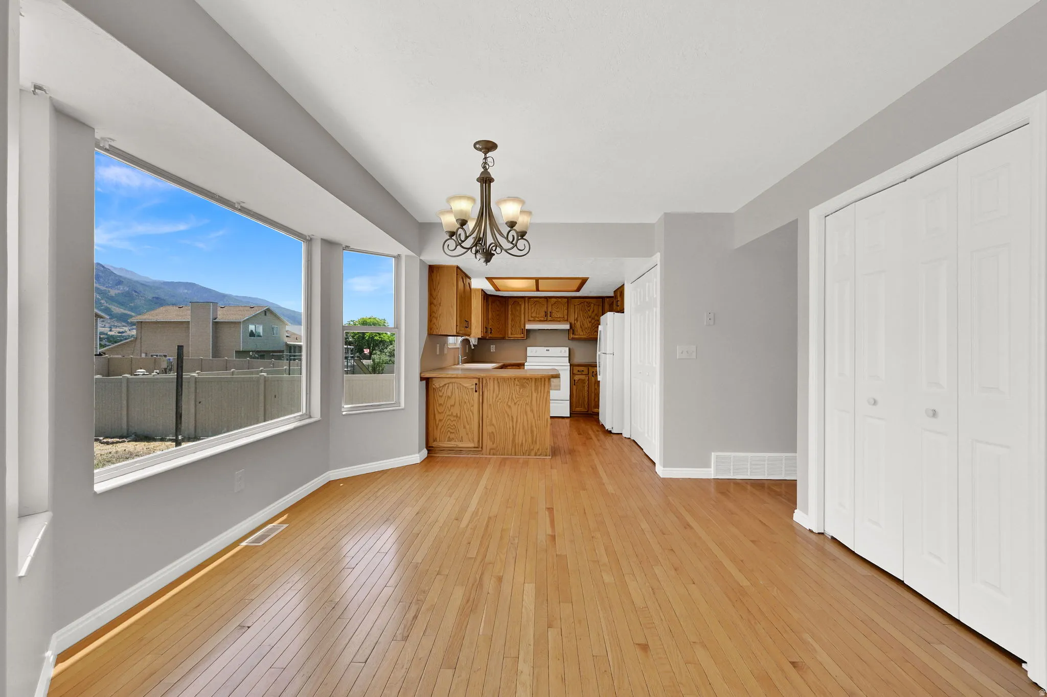 Hardwood flooring throughout the dining area and kitchen