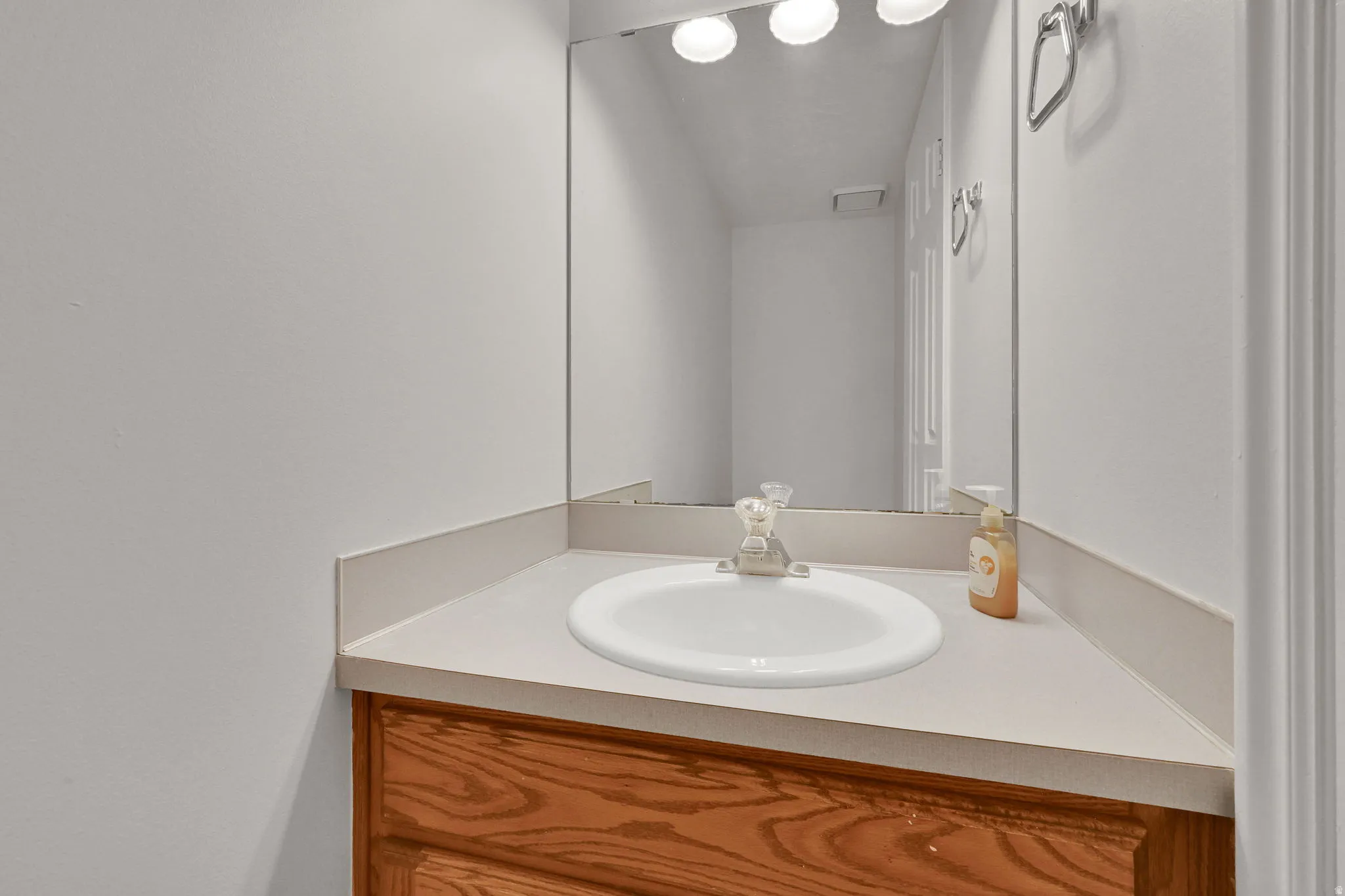 Light-toned countertop with integrated sink and chrome faucet