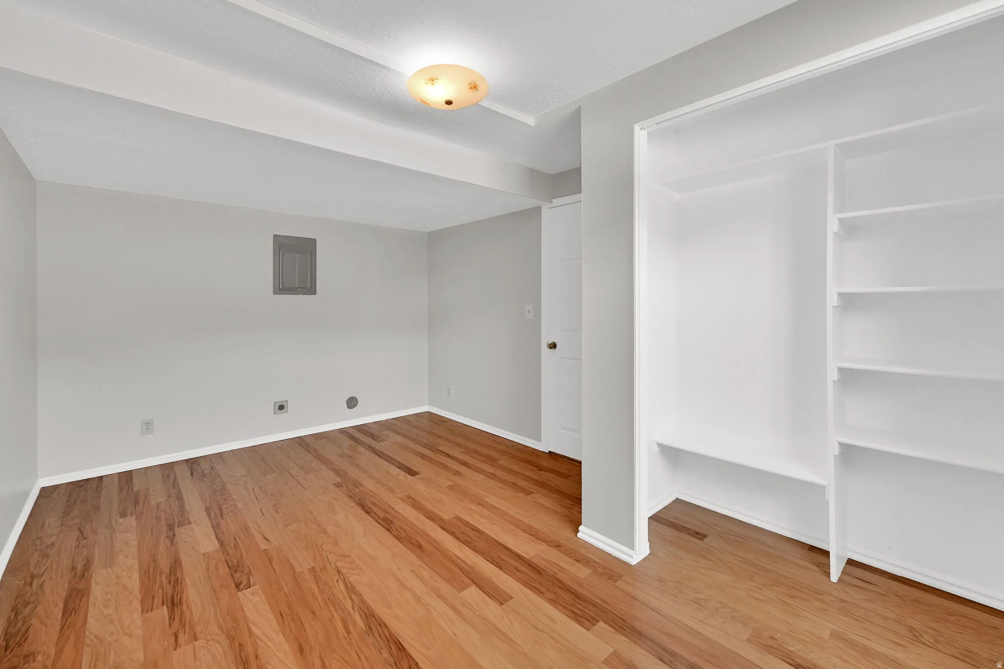 Wood-finish flooring throughout, complemented by a built-in closet with shelving