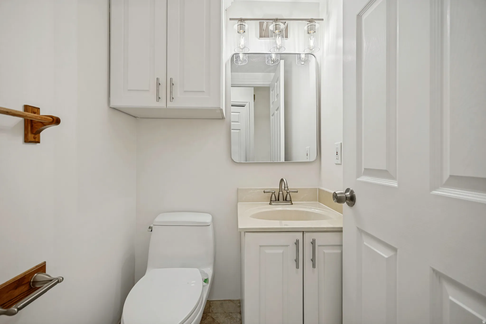White vanity with an integrated sink and brushed nickel faucet
