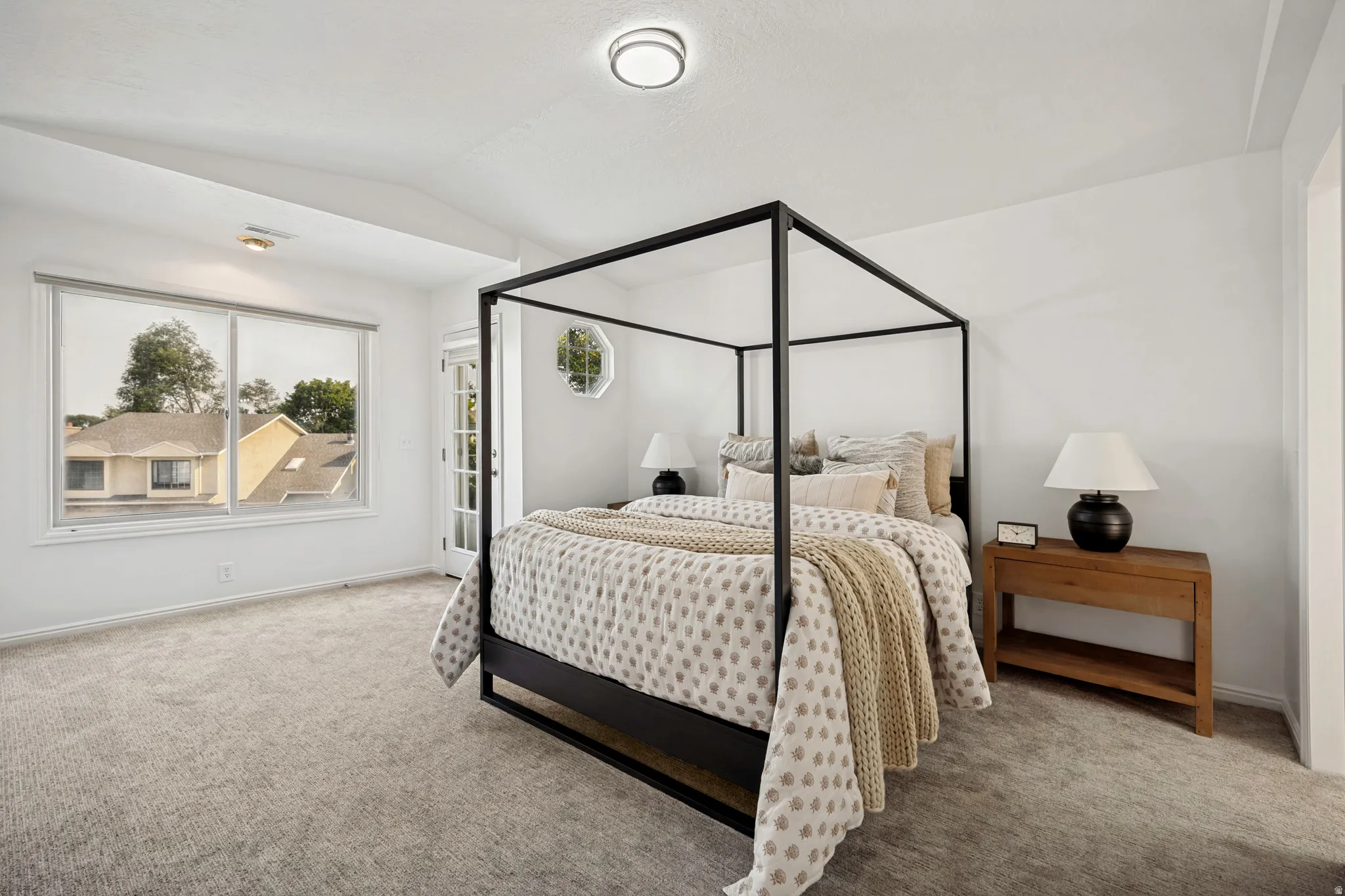 Carpeted room with a large window, white walls, and a recessed ceiling light