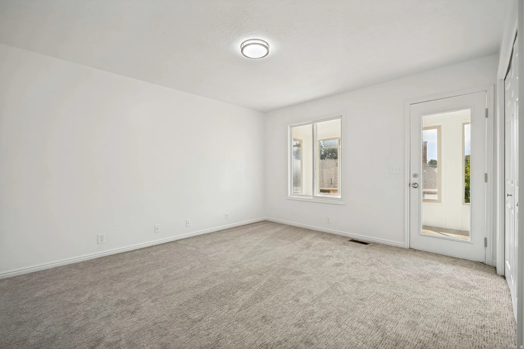 Light gray carpet flooring complementing bright white walls