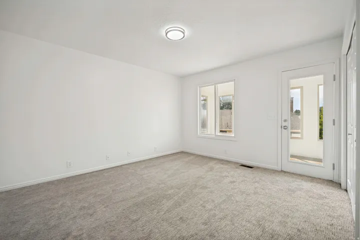 Light gray carpet flooring complementing bright white walls