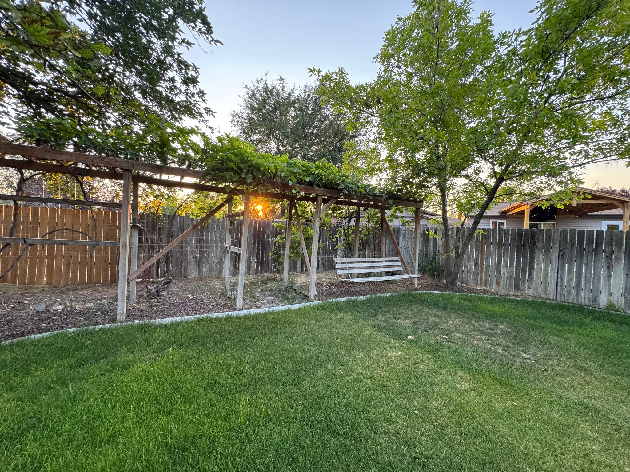 Expansive backyard with a lush green lawn