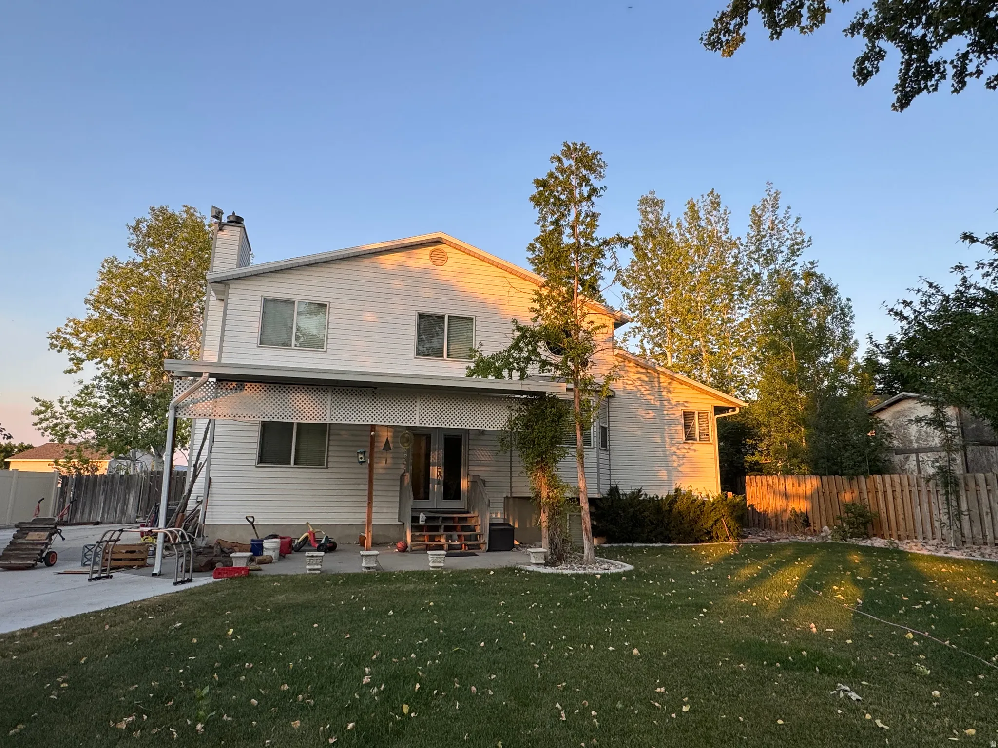 Two-story residence featuring Stuco and siding and a covered patio area