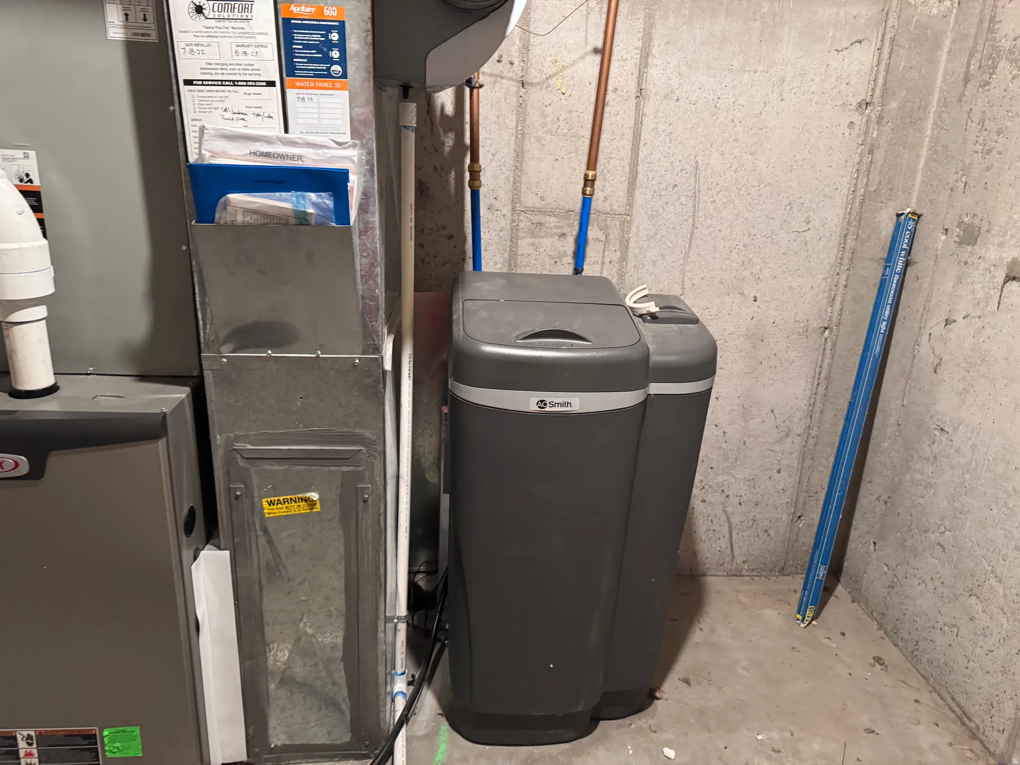 Mechanical area featuring a furnace, ductwork, and a water softening system