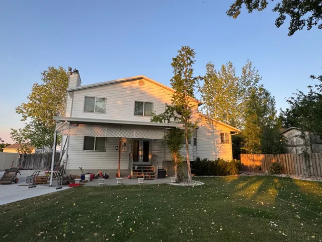 Two-story residence featuring Stuco and siding and a covered patio area