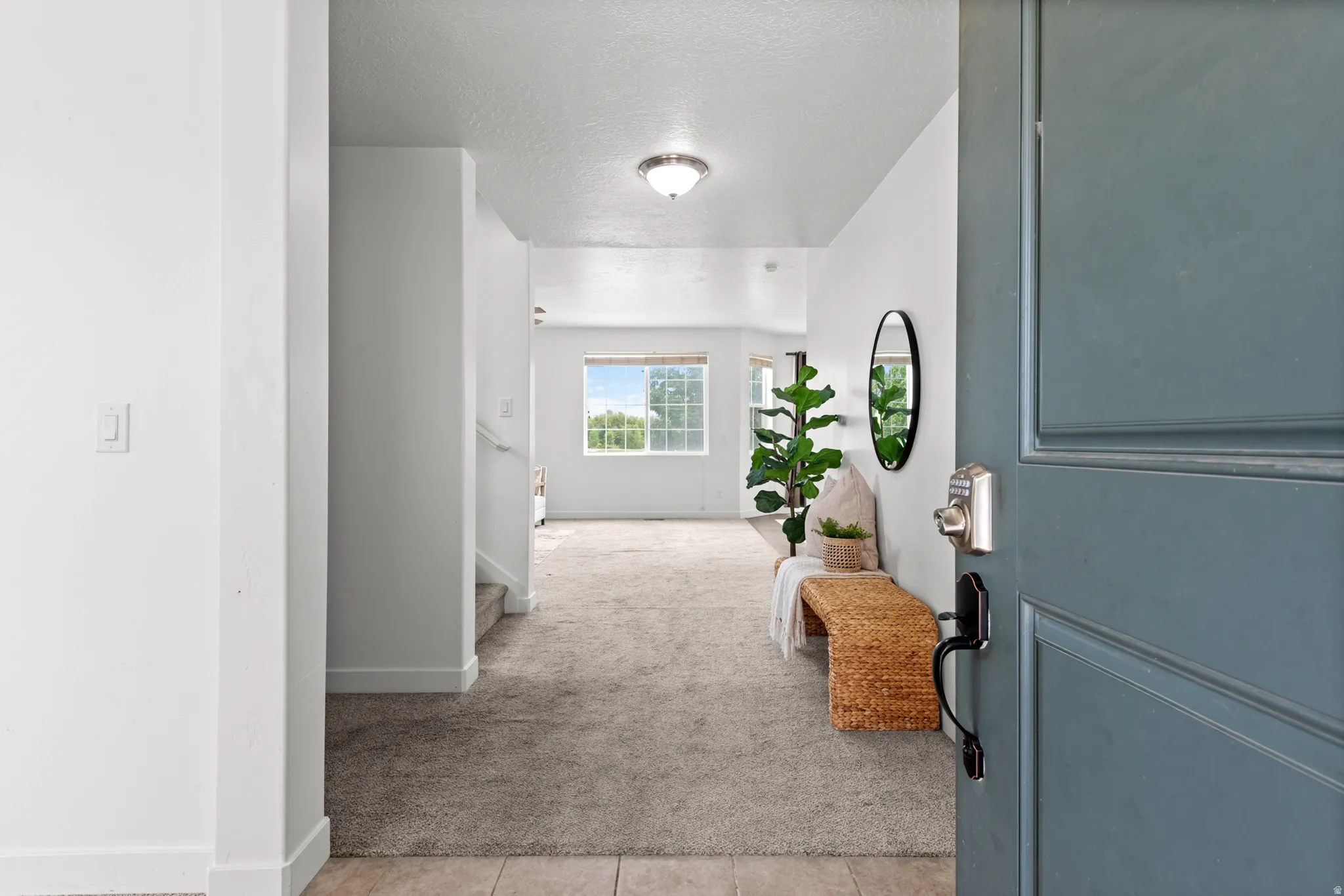 Inviting entryway with a paneled door, neutral wall color, and a flush mount ceiling light