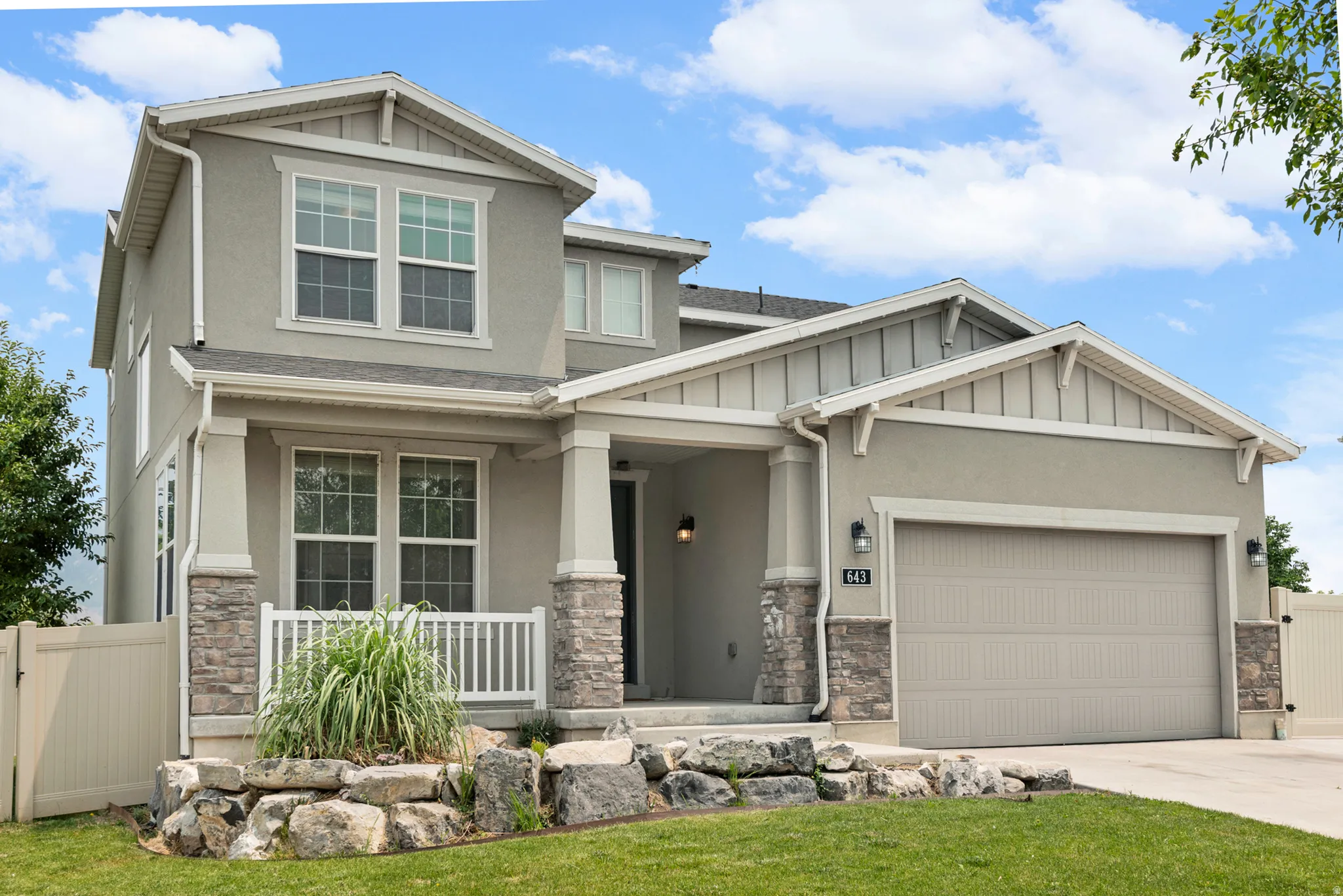 Contemporary stucco exterior with stone veneer accents