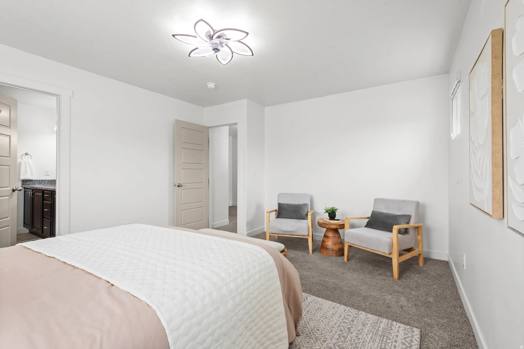 Spacious carpeted room featuring white walls and a contemporary ceiling fixture
