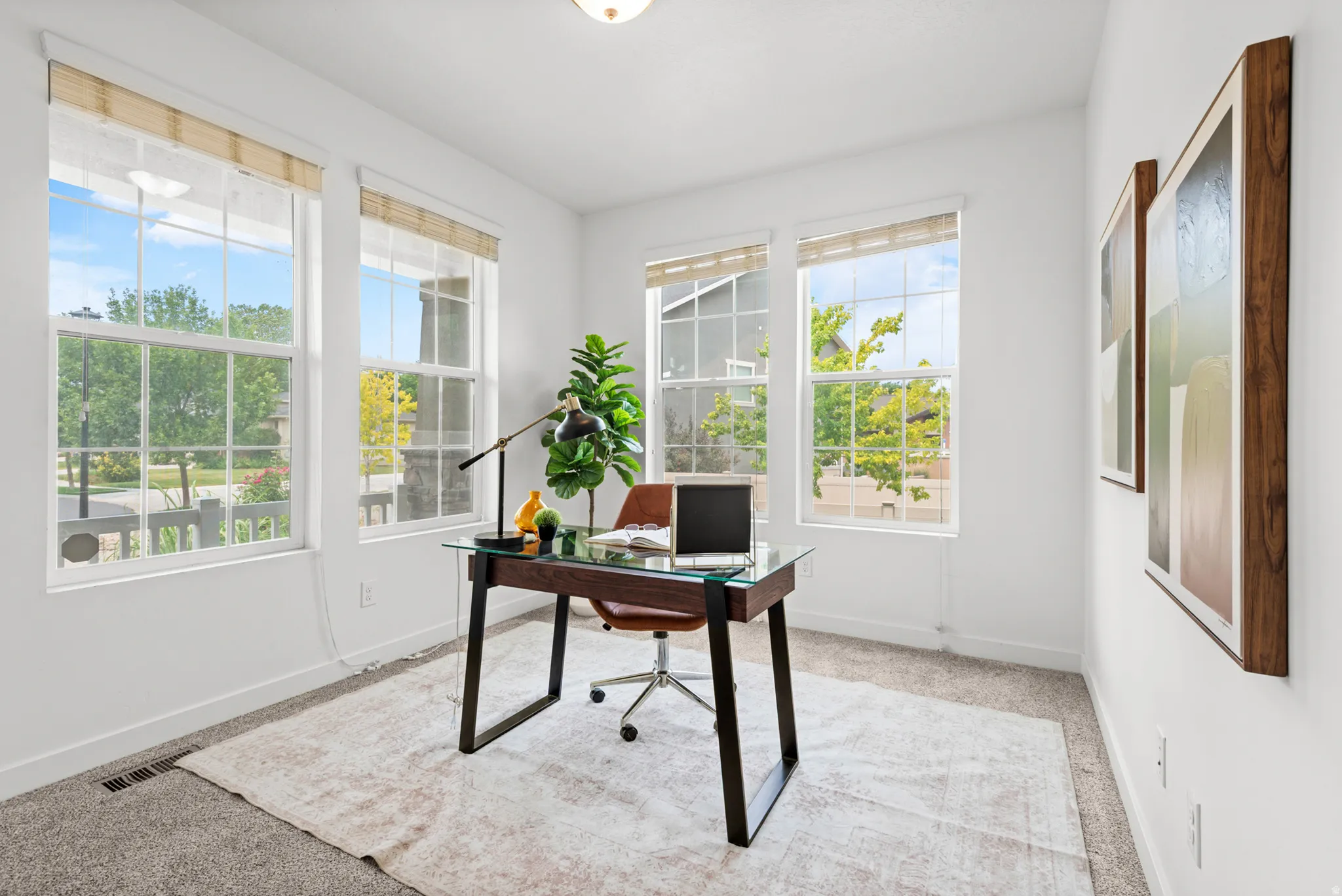 Bright room featuring multiple large windows with white frames and light-filtering shades
