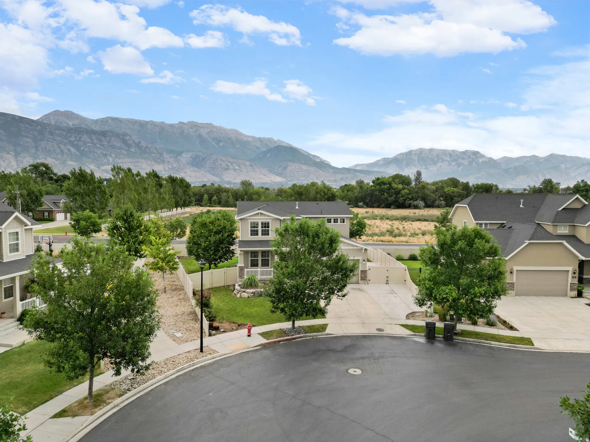 Residential street featuring a cul-de-sac and mountain backdrop