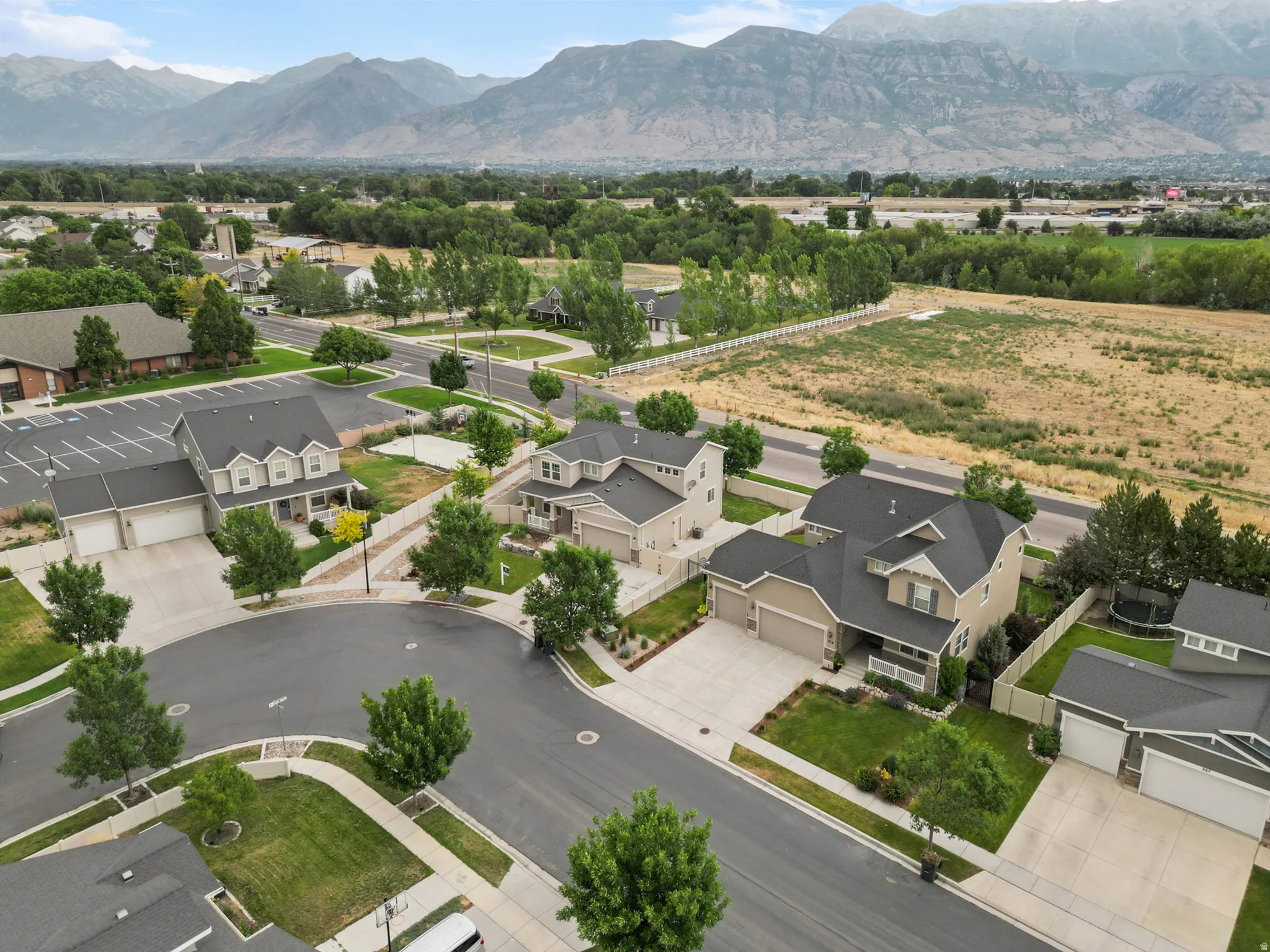 Aerial perspective showcasing a residential community with distant mountain ranges