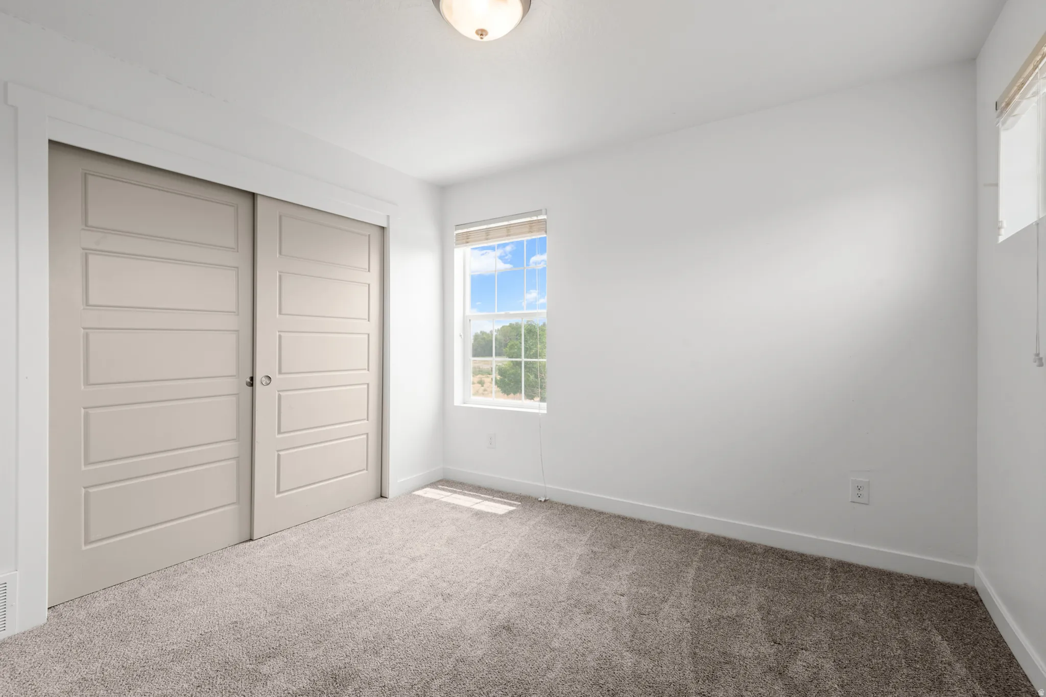 Room featuring neutral-toned carpeting and white walls