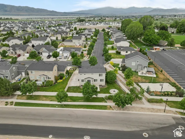 Aerial perspective of a developed residential area with distant mountains and a body of water